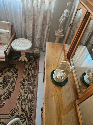 a living room with a table and a chair at Luxury Meets Convenience Near City & Travel Links in Pretoria