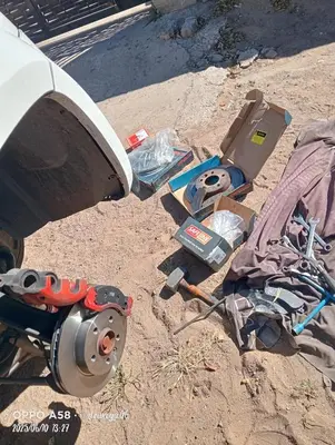 a pile of tools on the ground next to a car at V Mobile Automotive in Centurion