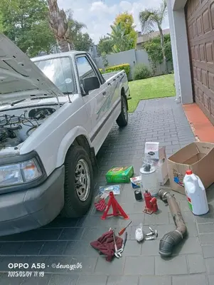 a car with its hood open on a driveway at V Mobile Automotive in Centurion