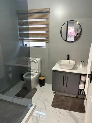 a bathroom with a sink and a toilet and a mirror at Unit 5 and 6 Homely Escapes in Phalaborwa