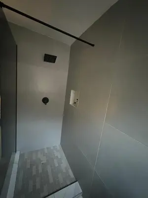 a bathroom with a white wall and a shower at Unit 5 and 6 Homely Escapes in Phalaborwa