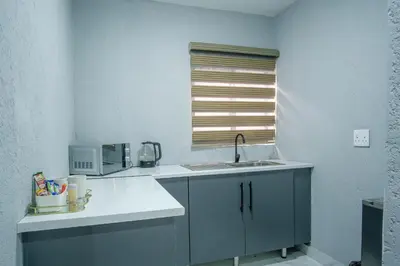 a kitchen with a sink and a window at Unit 5 and 6 Homely Escapes in Phalaborwa