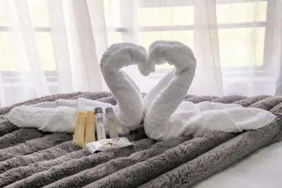 a bed with two swans shaped towels on it at Unit 5 and 6 Homely Escapes in Phalaborwa