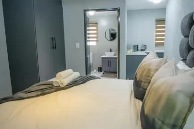 a bedroom with a bed with two towels on it at Unit 5 and 6 Homely Escapes in Phalaborwa