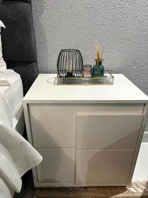a white night stand next to a bed at Unit 5 and 6 Homely Escapes in Phalaborwa