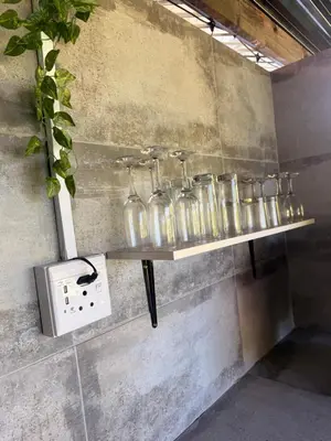 a shelf with glass jars on a wall at Soulfenda guest house in Graskop