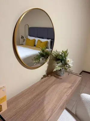 a mirror over a table in a bedroom with a bed at Soulfenda guest house in Graskop