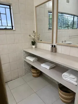 a bathroom with a sink and a mirror at Soulfenda guest house in Graskop