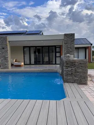 a swimming pool in front of a house at Euphoria 447 in Naboomspruit