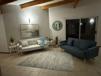 a living room with two couches and a couch at Catrachos Place in Pretoria