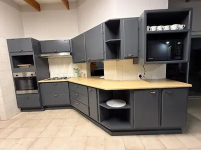 a large kitchen with gray cabinets and a counter at Catrachos Place in Pretoria