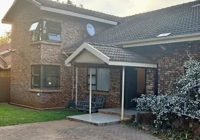 a brick house with an awning on the front of it at Chandané Guesthouse in Thabazimbi