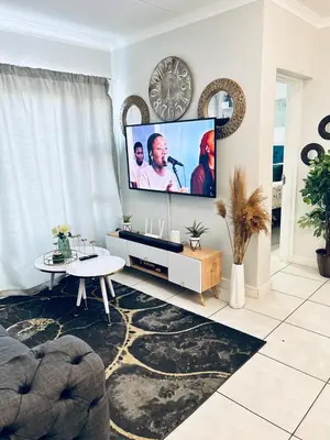 a living room with a large screen tv at The Blyde bnb in Pretoria