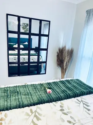 a bed in a room with a large window at The Blyde bnb in Pretoria
