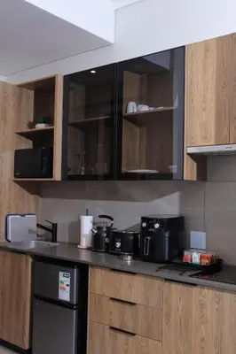 a kitchen with a counter top with pots and pans at Luxurious and Modern, Menlyn Maine Residences 825 in Pretoria