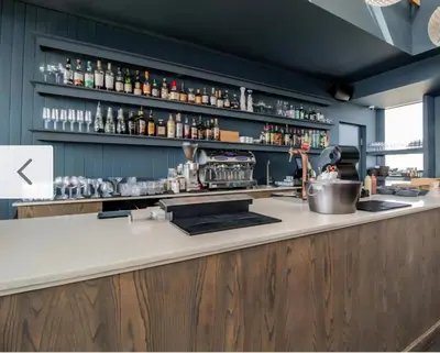 a kitchen with a counter with a bar with alcohol at Luxurious and Modern, Menlyn Maine Residences 825 in Pretoria