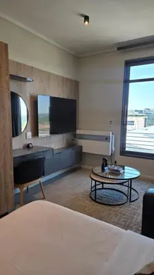 a room with a bed and a table and a tv at Luxurious and Modern, Menlyn Maine Residences 825 in Pretoria