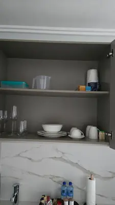 a kitchen shelf with plates and dishes on it at Luxurious and Modern, Menlyn Maine Residences 825 in Pretoria