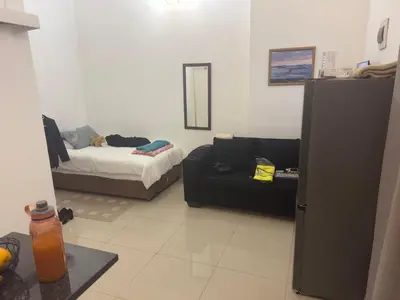 a living room with a couch and a bed at Airport Guest House in Kempton Park