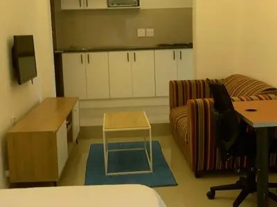 a living room with a couch and a table at Airport Guest House in Kempton Park