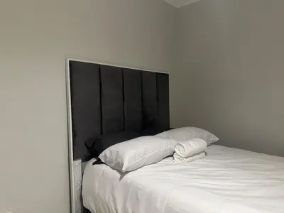 a white bed with two pillows on top of it at The Blyde - Stay Iconic 2 bed Apartment in Pretoria