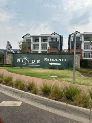 a sign on a wall in front of some buildings at The Blyde - Stay Iconic 2 bed Apartment in Pretoria