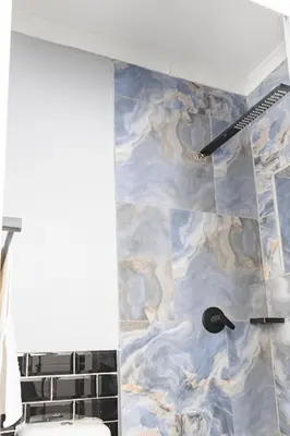a bathroom with a blue and marble wall at Milan Coproperties in Kempton Park