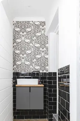 a bathroom with black and white tile and a sink at Milan Coproperties in Kempton Park