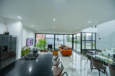 a kitchen and living room with a table and chairs at Sucassa 54 - Luxury 2 Bedroom - Dam & Mountain View in Hartbeespoort
