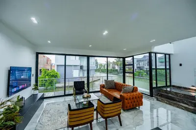 a living room with a couch and a table and chairs at Sucassa 54 - Luxury 2 Bedroom - Dam & Mountain View in Hartbeespoort