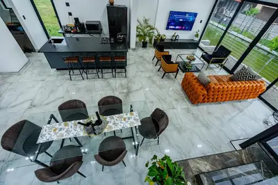 an aerial view of a living room with a table and chairs at Sucassa 54 - Luxury 2 Bedroom - Dam & Mountain View in Hartbeespoort