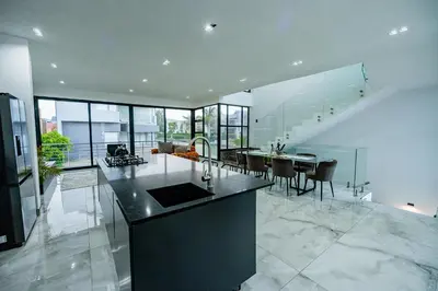 a large kitchen and dining room with a table and chairs at Sucassa 54 - Luxury 2 Bedroom - Dam & Mountain View in Hartbeespoort