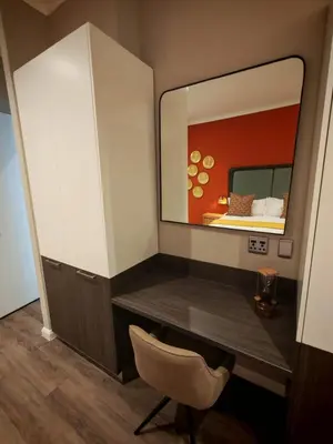a dressing table with a mirror and a chair at Menlyn Maine Trilogy Apartment 1316 & 1316A in Pretoria