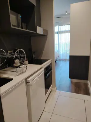 a kitchen with white cabinets and a stove top oven at Menlyn Maine Trilogy Apartment 1316 & 1316A in Pretoria