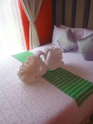 a bed with two swans decoration on it at Express at Urban Cove in Nelspruit