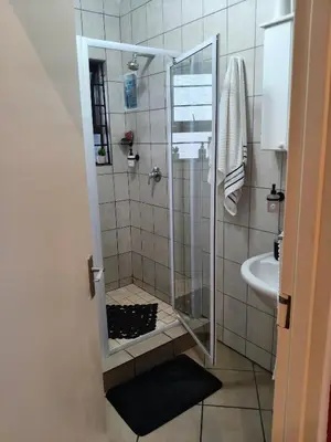 a shower with a glass door in a bathroom at Express at Urban Cove in Nelspruit