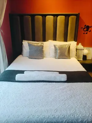 a bedroom with a bed with white sheets and pillows at Express at Urban Cove in Nelspruit