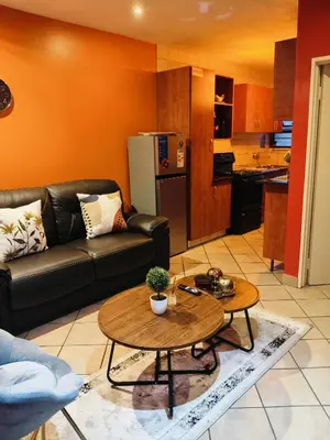 a living room with a couch and a table at Express at Urban Cove in Nelspruit