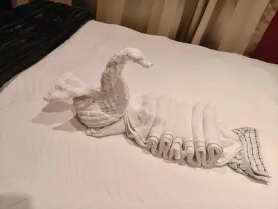 a towel of a chicken on a bed at Express at Urban Cove in Nelspruit