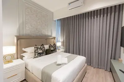 a bedroom with a large white bed and a window at 932 menlyn maine in Pretoria