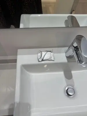 a white bathroom sink with a chrome faucet at 932 menlyn maine in Pretoria