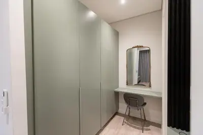 a dressing room with a chair and a mirror at 932 menlyn maine in Pretoria