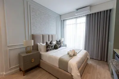 a bedroom with a large bed and a window at 932 menlyn maine in Pretoria