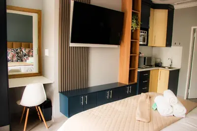 a bedroom with a bed with towels and a mirror at 1 on Brandspruit in Secunda
