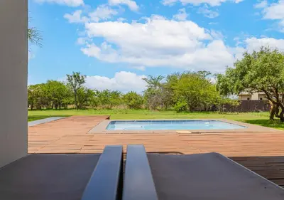 a swimming pool sitting on top of a patio at Bush Lodge Zebula 82 - 2 x 2B Chalets in Warmbaths