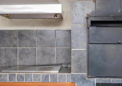 a kitchen with a stove and a tiled wall at Bush Lodge Zebula 82 - 2 x 2B Chalets in Warmbaths