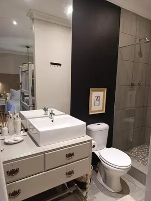 a bathroom with a sink and a toilet and a shower at Net 'n Bed in Middelburg