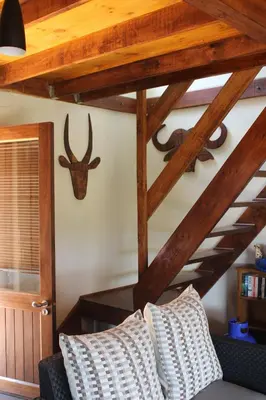 a living room with a couch and a wooden ceiling at Oppiberg Cottage with River View in Hartbeespoort