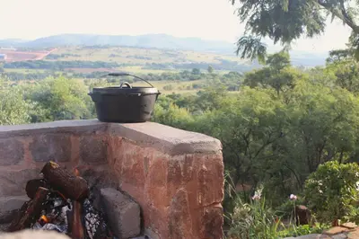a pot sitting on top of a fire pit at Oppiberg Cottage with River View in Hartbeespoort