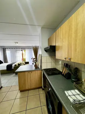 a kitchen with a sink and a counter top at Protea Apartment Midrand in Midrand